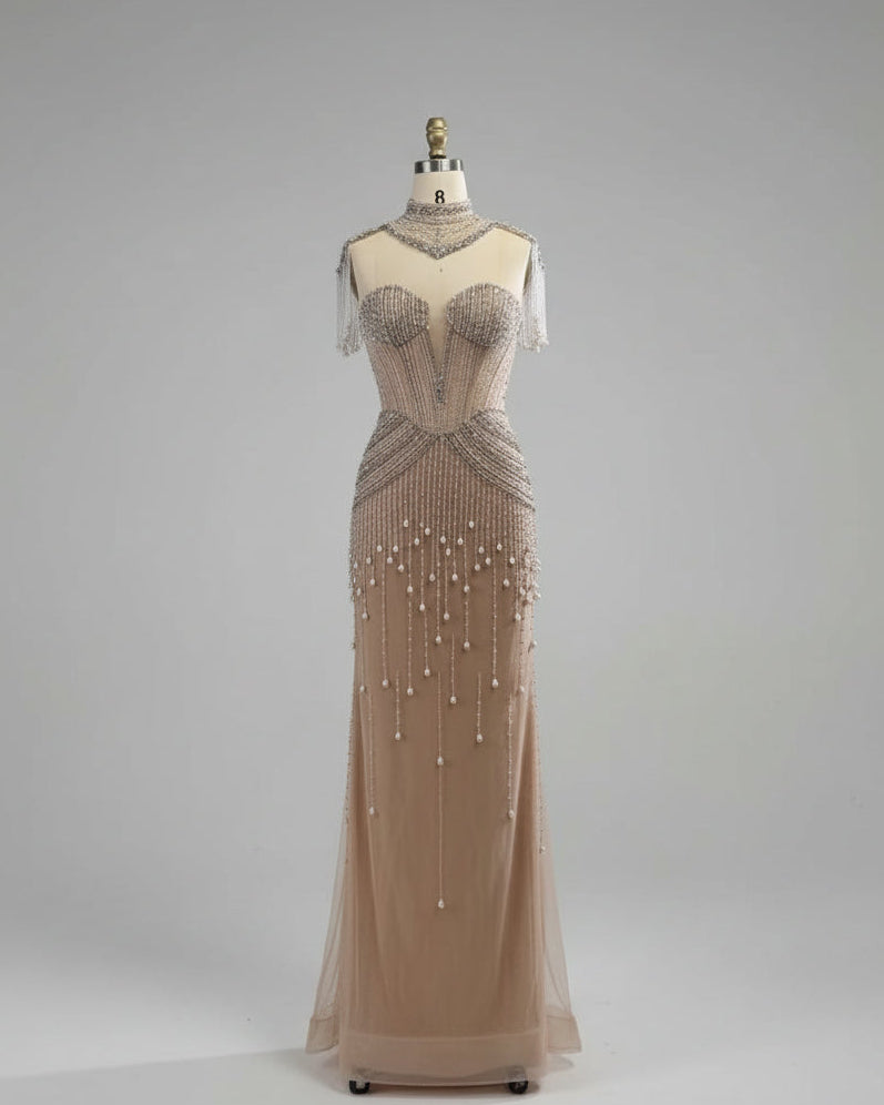 Beaded evening gown on a mannequin against a white paneled wall.