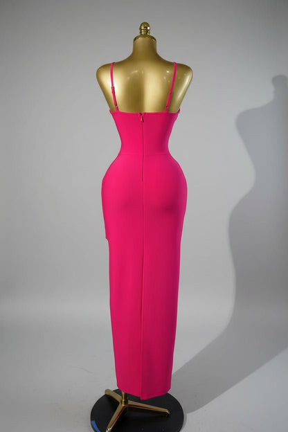 Pink dress with a decorative back on a mannequin against a metallic background