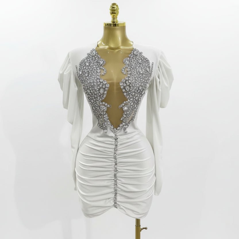 White dress with silver embellishments on a mannequin against a gray background